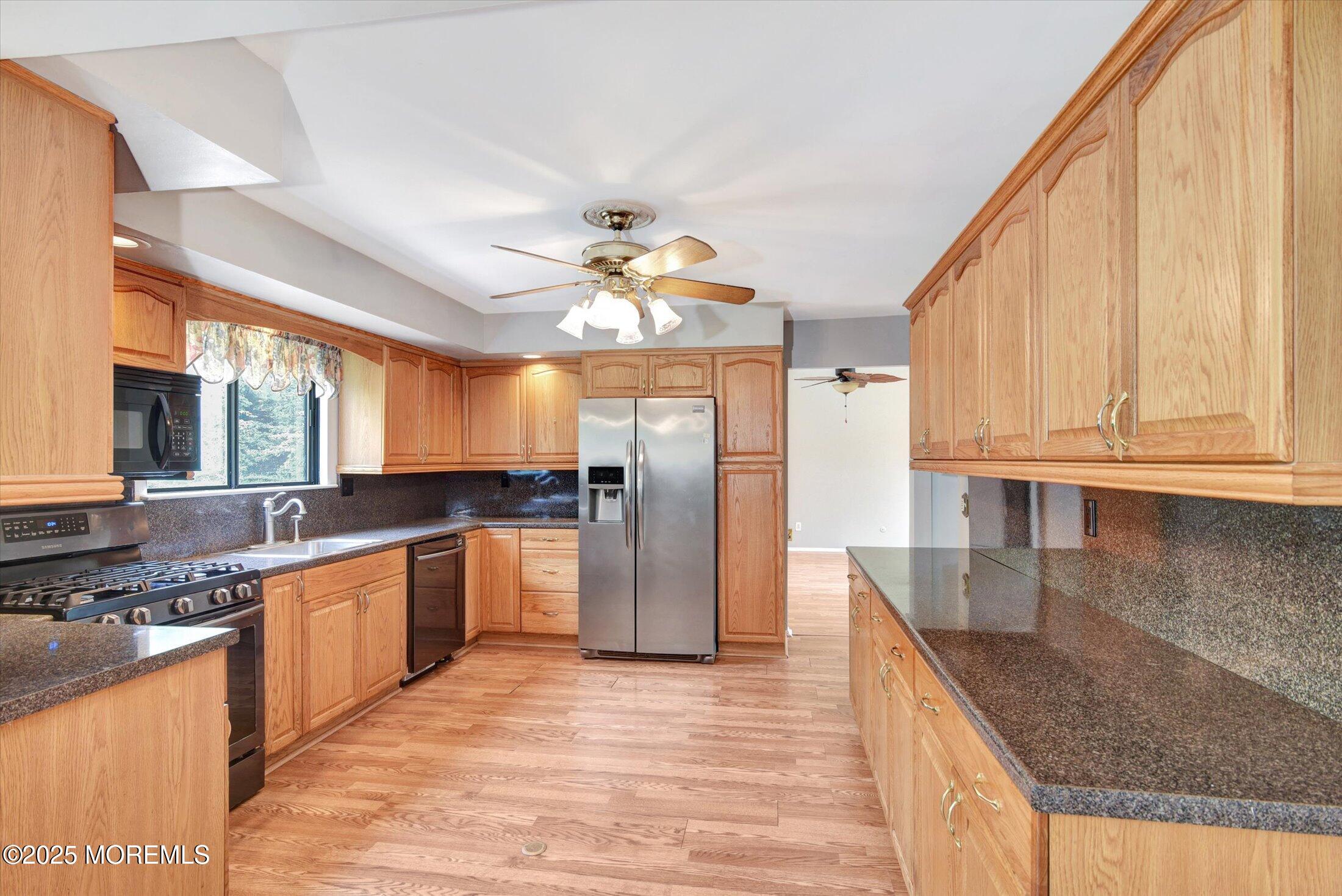 19 Northwoods Road Asbury Park, NJ 07712 - Photo 16 of 79 a kitchen with stainless steel appliances granite countertop a sink and dishwasher a oven with white cabinets