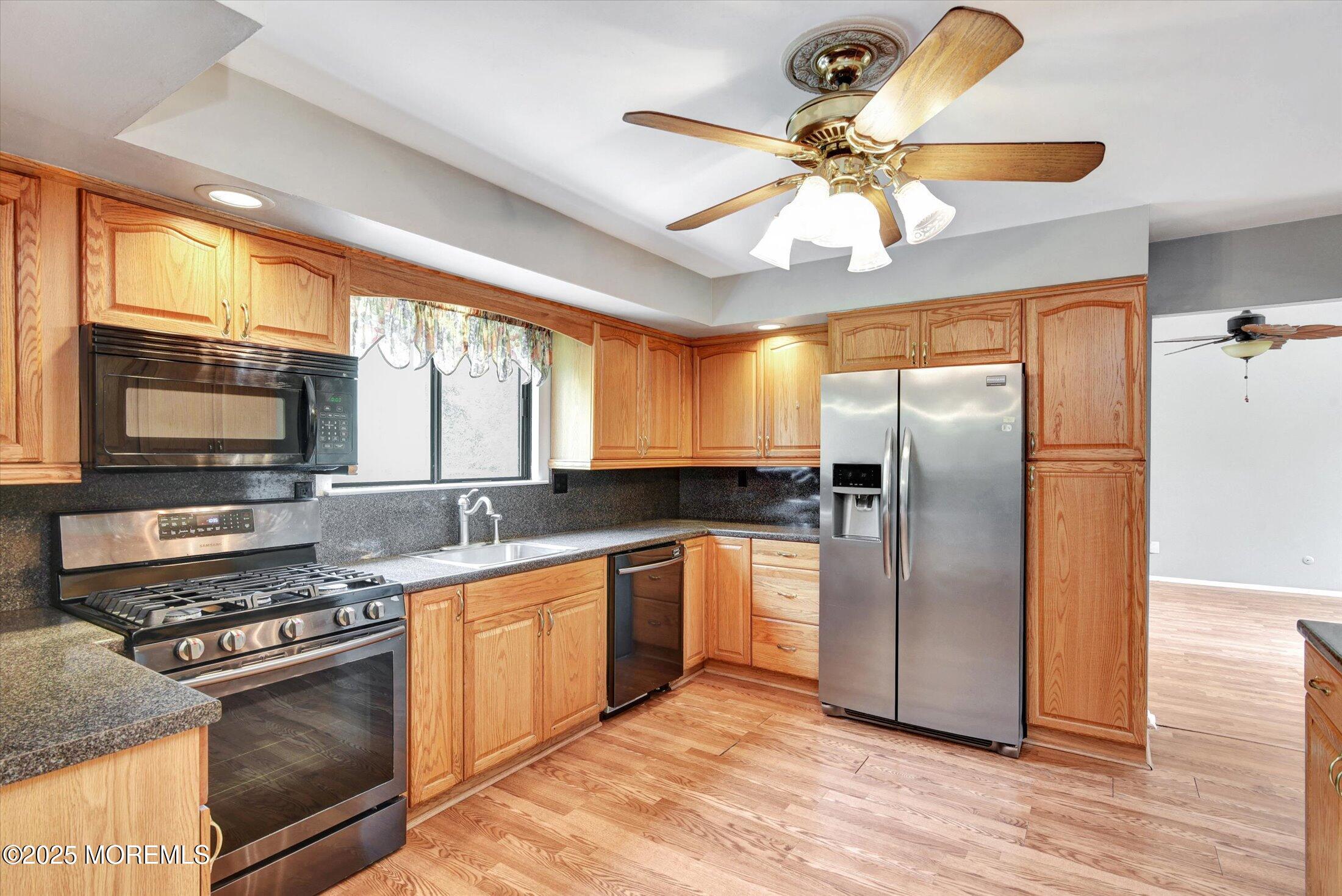 19 Northwoods Road Asbury Park, NJ 07712 - Photo 17 of 79 a kitchen with stainless steel appliances granite countertop a refrigerator a stove and a sink
