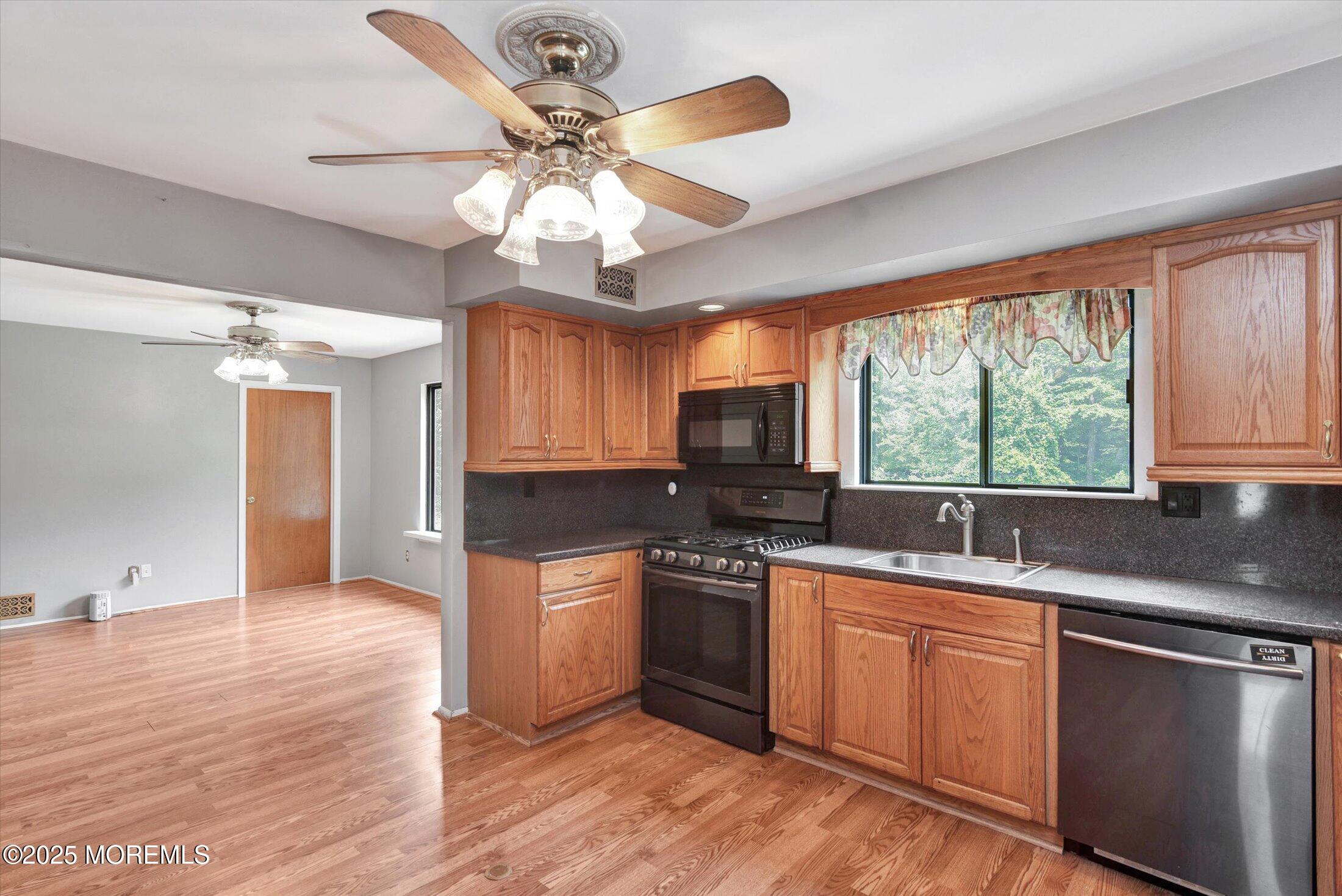 19 Northwoods Road Asbury Park, NJ 07712 - Photo 18 of 79 a kitchen with stainless steel appliances granite countertop a sink cabinets a window and a counter space