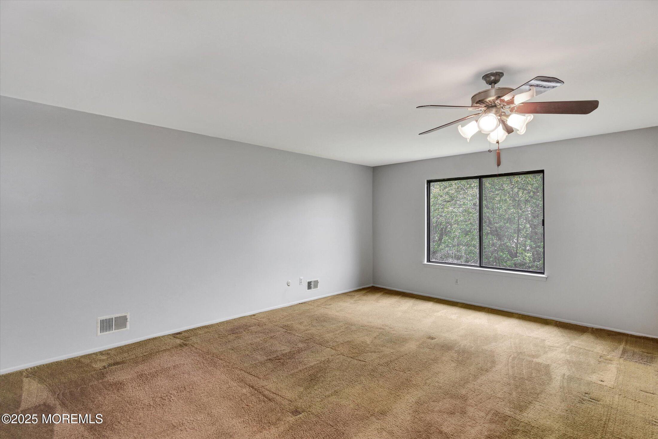 19 Northwoods Road Asbury Park, NJ 07712 - Photo 30 of 79 a view of a big room with windows and chandelier fan