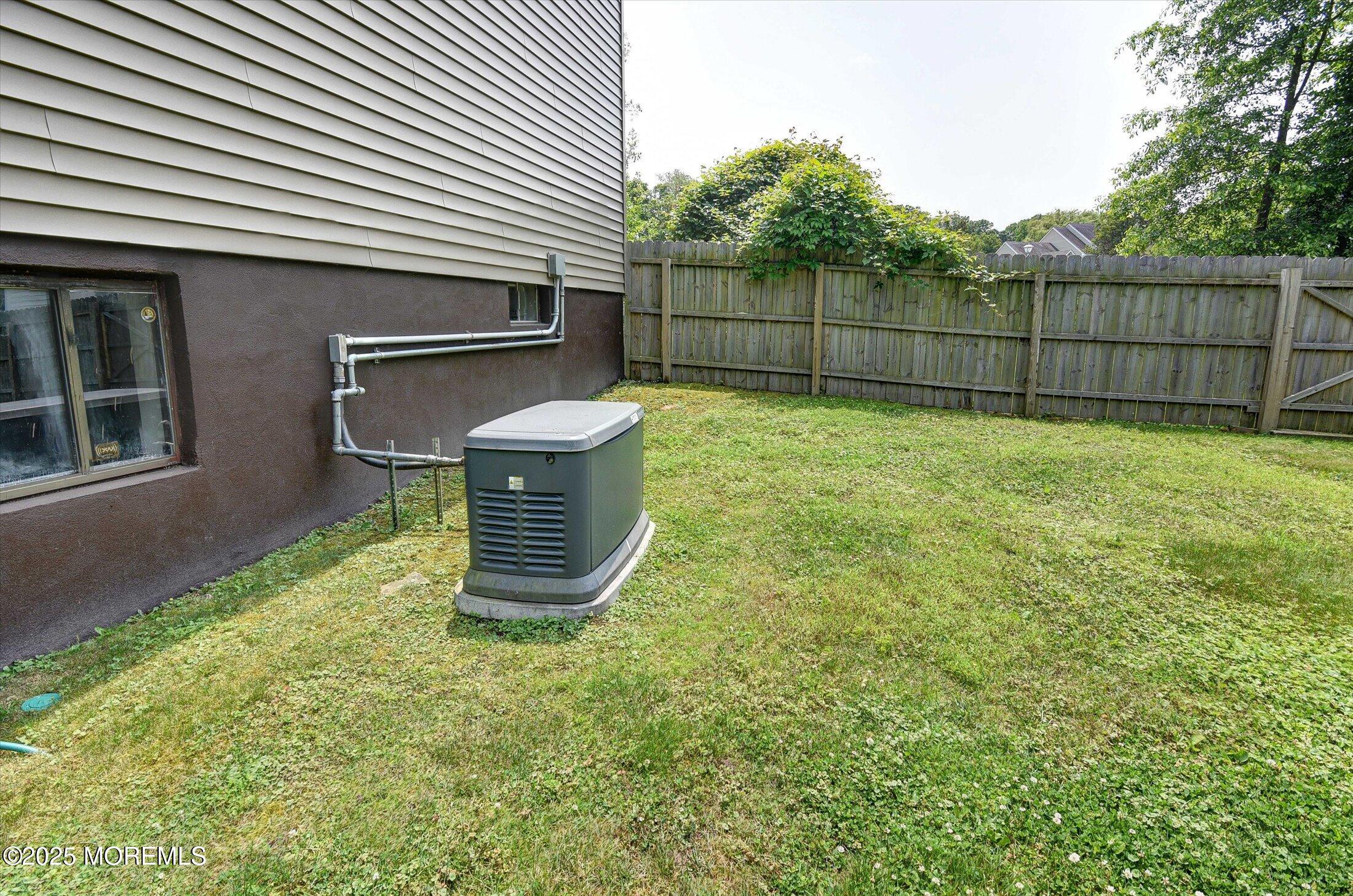19 Northwoods Road Asbury Park, NJ 07712 - Photo 47 of 79 a view of a backyard with plants and brick wall