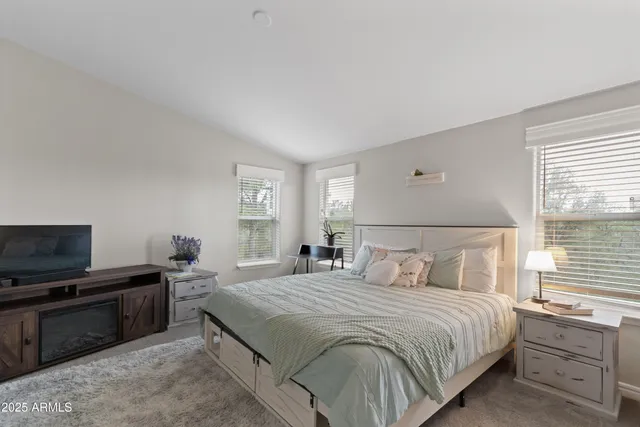 a bedroom with a bed and a television