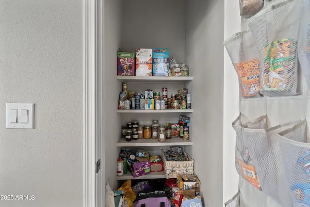 a kitchen with granite countertop a sink a stove and cabinets