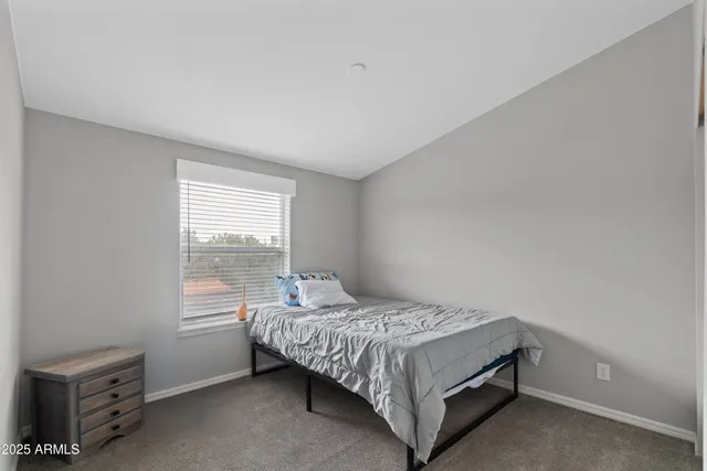 a bed room with a bed and a window