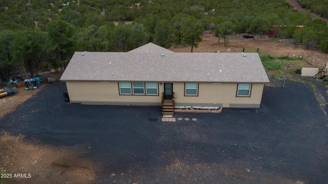 a aerial view of a house with a yard