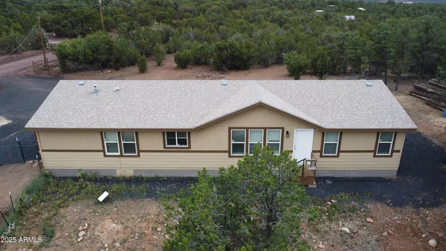 a aerial view of a house with a yard and street view