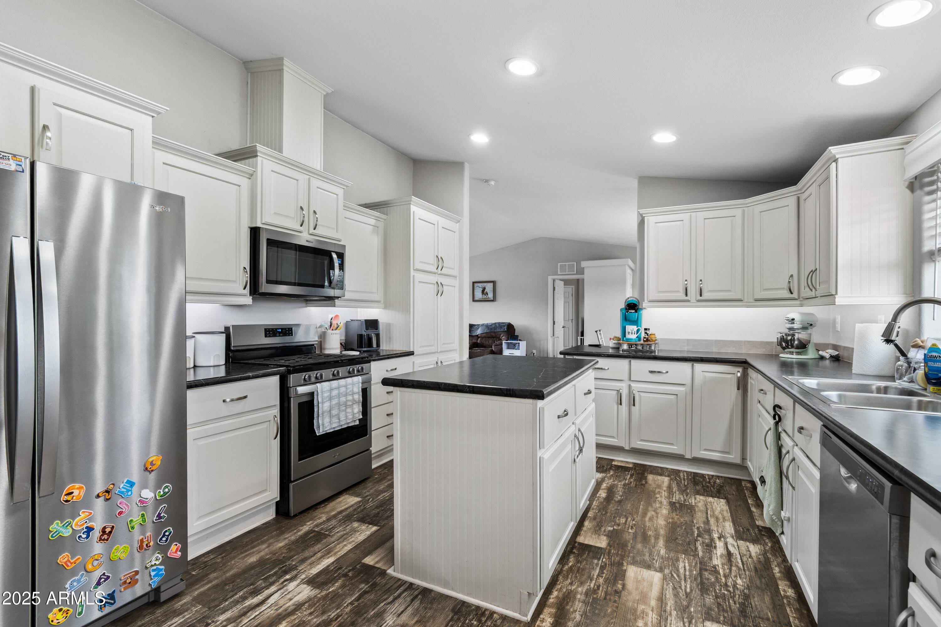 65 Co Road Show Low, AZ 85901 - Photo 8 of 38 a kitchen with stainless steel appliances a sink dishwasher a refrigerator oven a stove top oven a sink and dishwasher with wooden floor