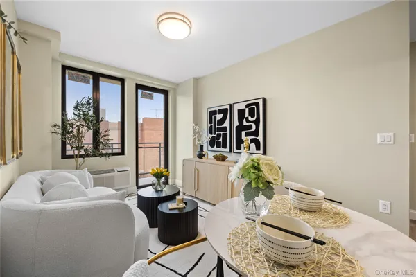 a living room with furniture and floor to ceiling window