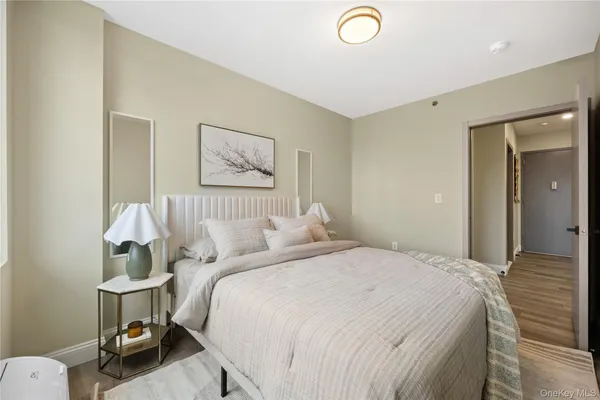 a bedroom with a bed and a lamp