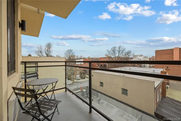 a view of a chairs and table in the balcony