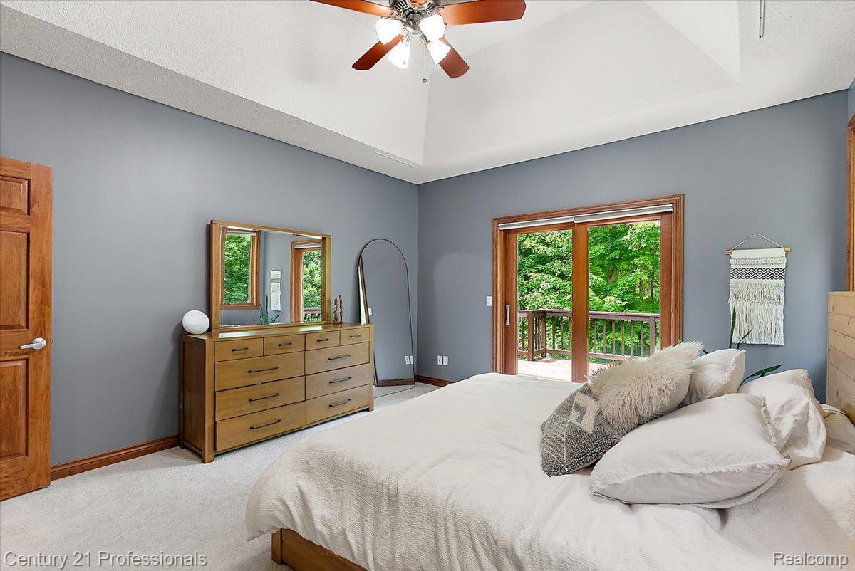 9867 Rainbow Ridge Drive Schoolcraft, MI 49087 - Photo 33 of 82 Vaulted ceiling bedroom with a ceiling fan, light gray wall color, and light-colored carpeting