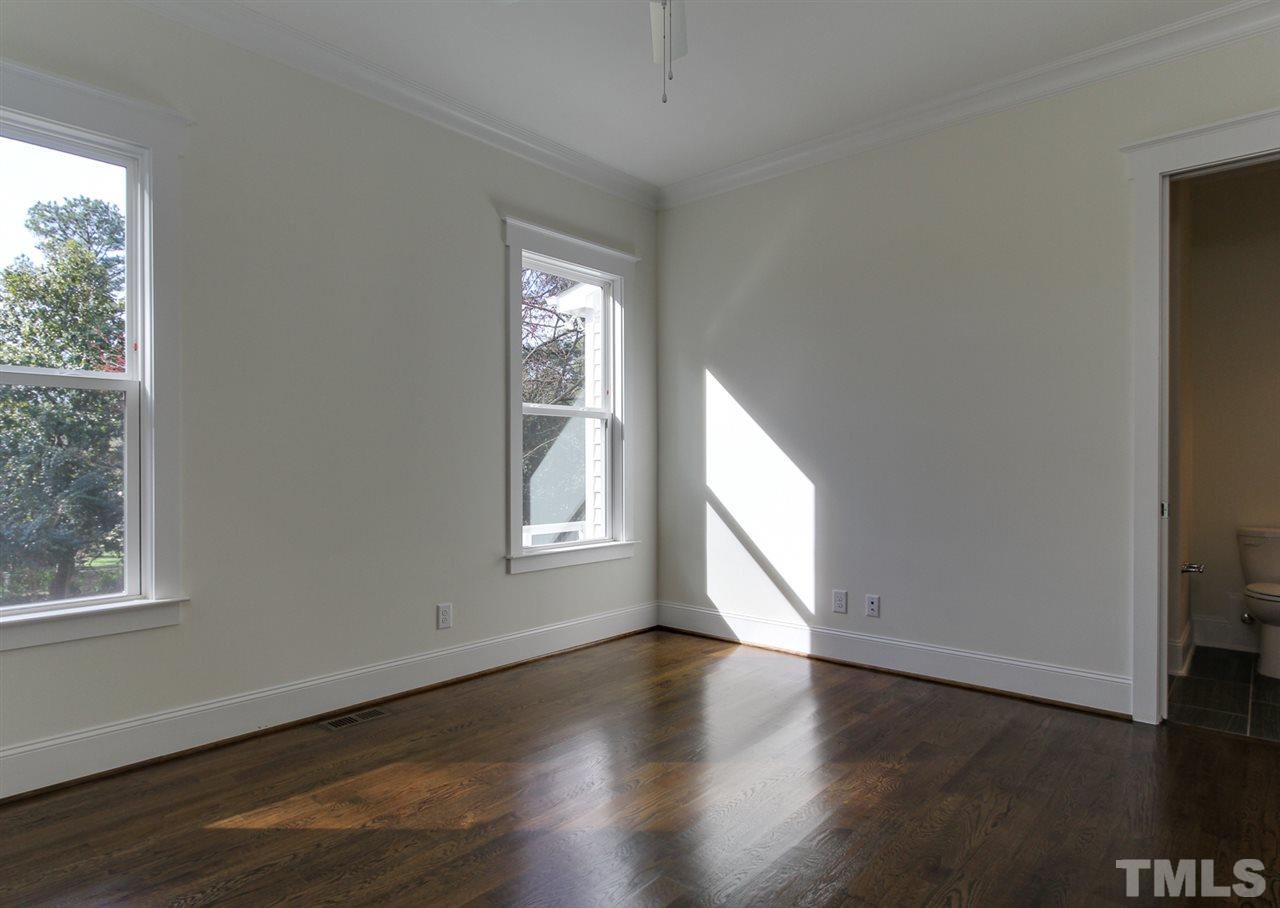 701 Shelley Road Raleigh, NC 27609 - Photo 14 of 25 an empty room with wooden floor and windows