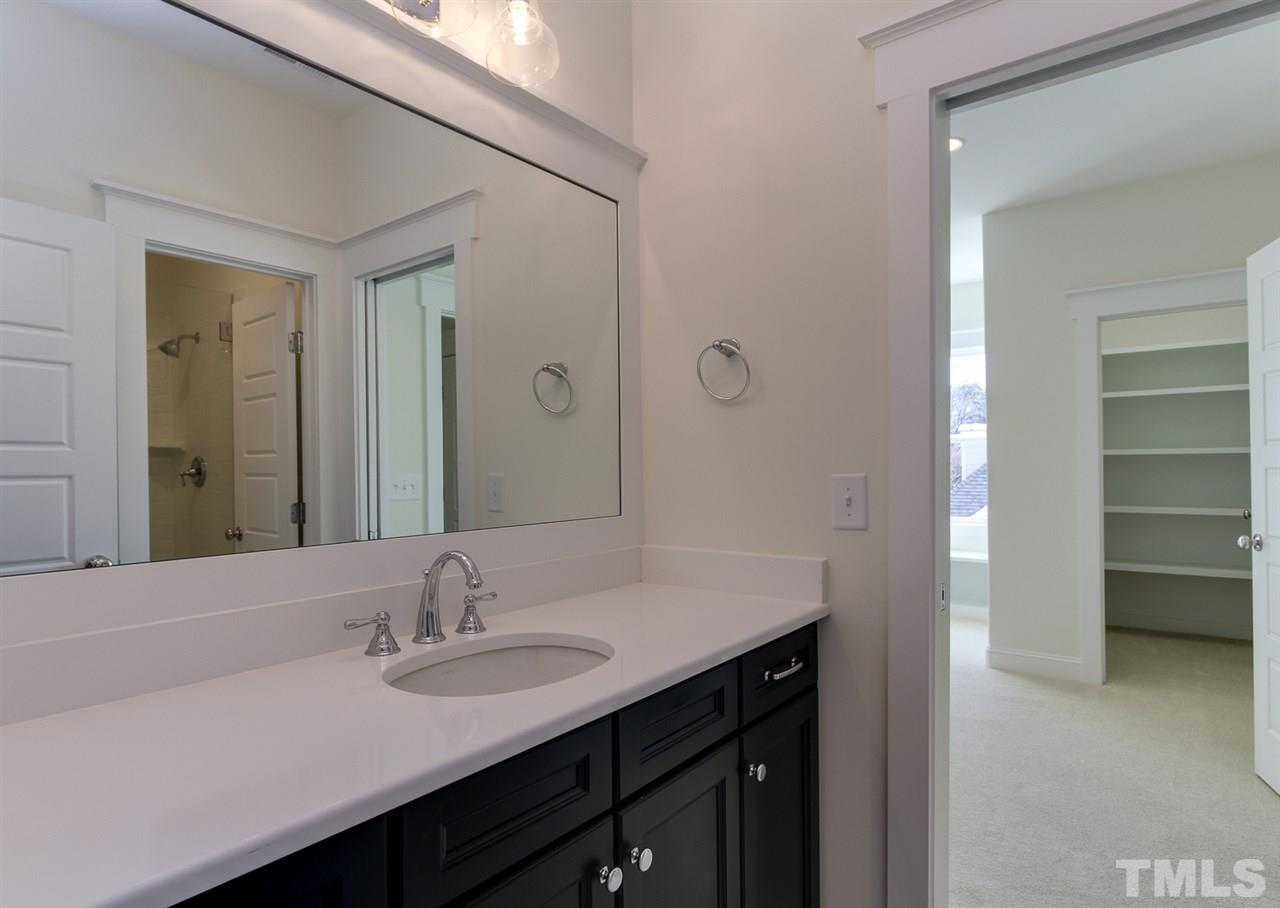 701 Shelley Road Raleigh, NC 27609 - Photo 22 of 25 a bathroom with a sink and a mirror
