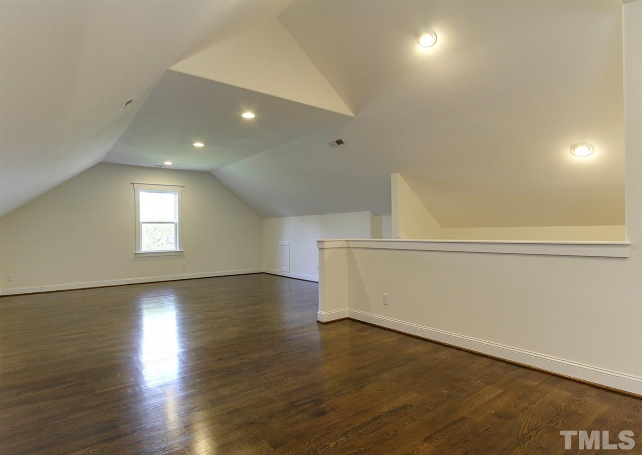 701 Shelley Road Raleigh, NC 27609 - Photo 23 of 25 an empty room with wooden floor and windows