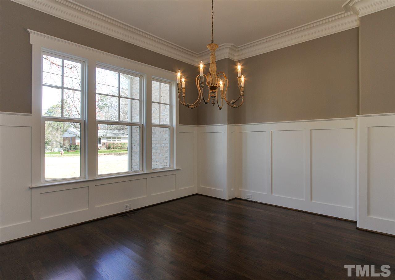 701 Shelley Road Raleigh, NC 27609 - Photo 5 of 25 a view of an empty room with wooden floor and a window