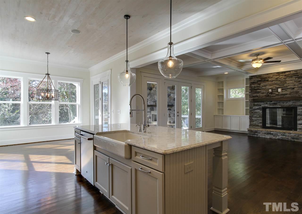 701 Shelley Road Raleigh, NC 27609 - Photo 9 of 25 a kitchen with stainless steel appliances granite countertop a sink a oven and a wooden floor