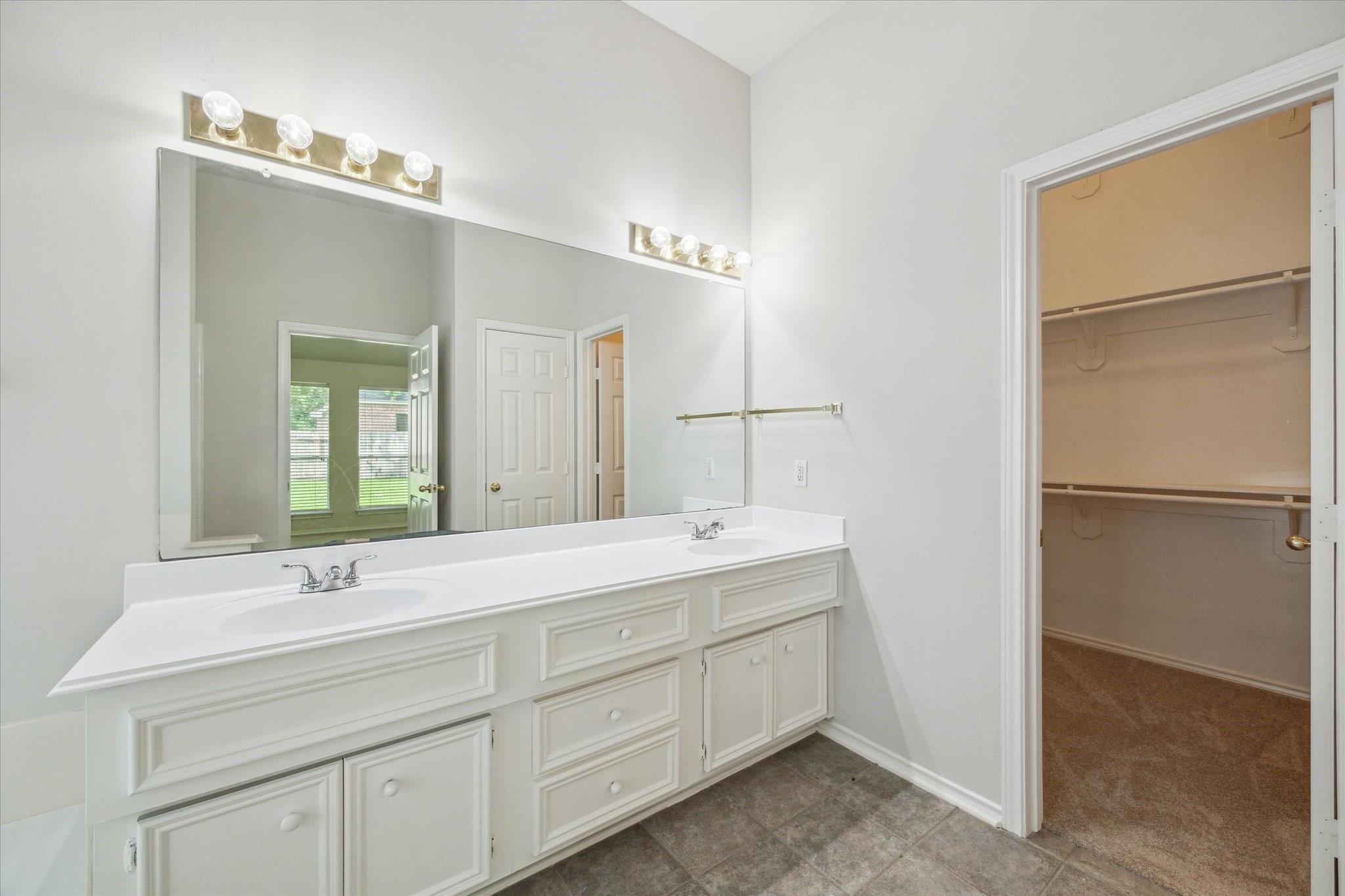 8211 Broken Timber Way Houston, TX 77095 - Photo 12 of 15 a bathroom with a double vanity sink and mirror