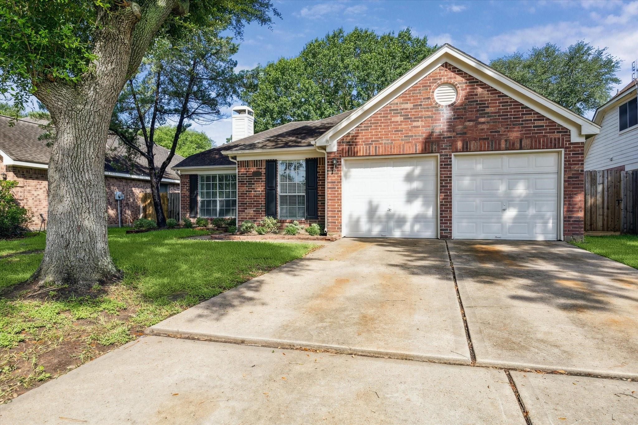 8211 Broken Timber Way Houston, TX 77095 - Photo 15 of 15 a front view of a house with a yard and garage