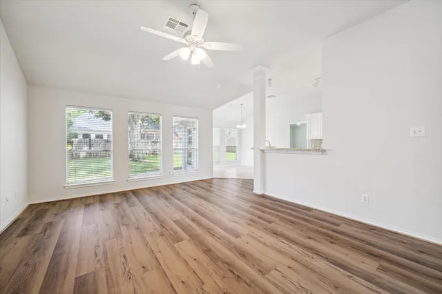 wooden floor in an empty room with a window