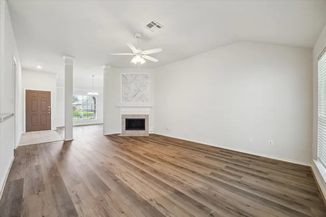 wooden floor in an empty room with a fireplace