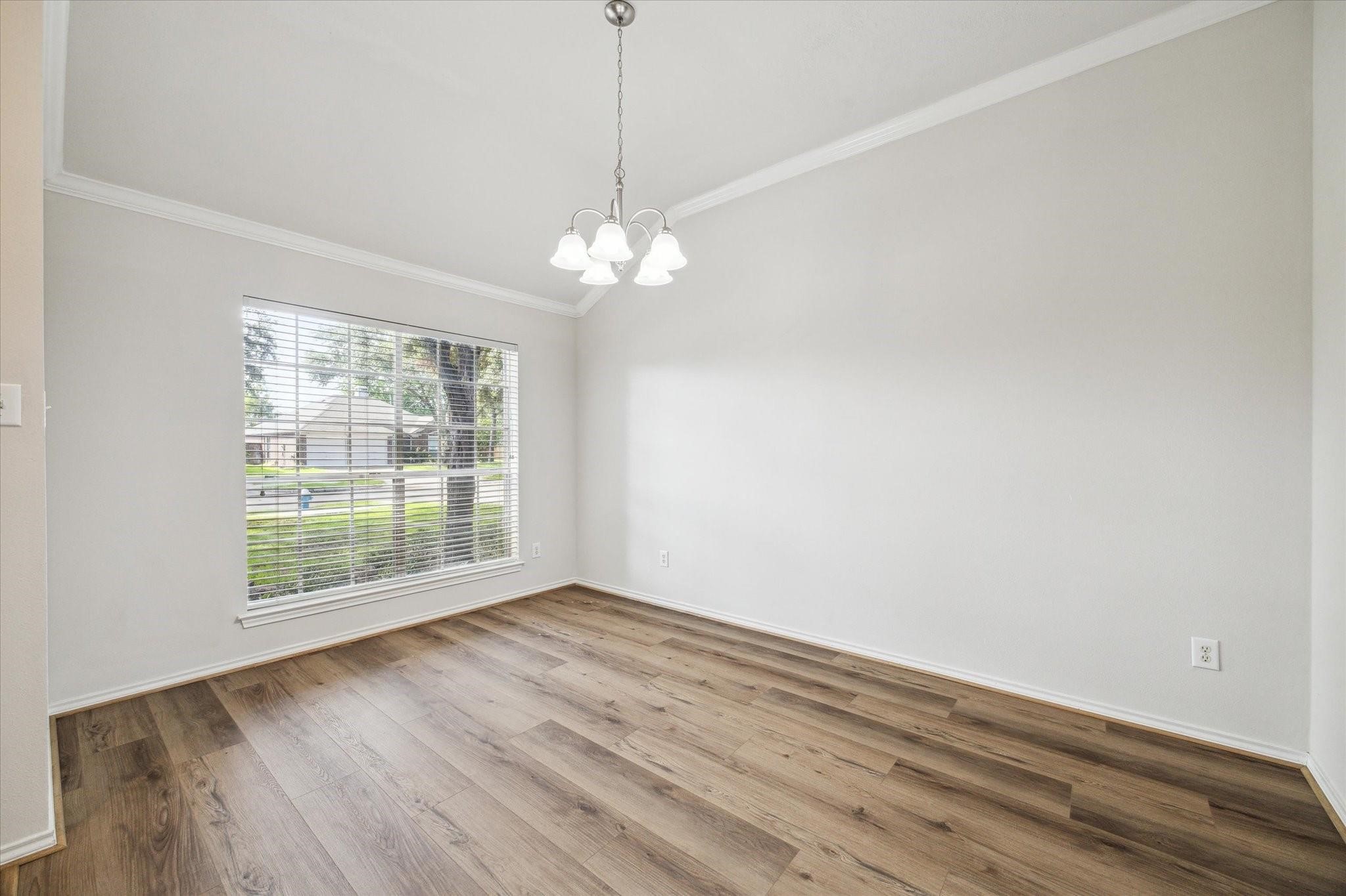 8211 Broken Timber Way Houston, TX 77095 - Photo 7 of 15 a view of an empty room with wooden floor and a window