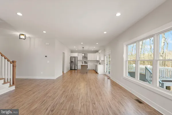 a kitchen with a sink a stove a refrigerator and white cabinets