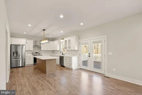a kitchen with stainless steel appliances a sink stove and refrigerator