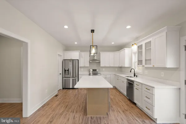 a kitchen with a sink a stove and cabinets