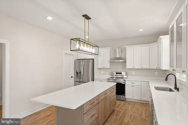 a view of a hallway with wooden floor and entryway