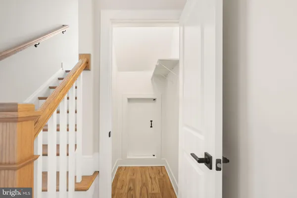 a view of room with stairs and wooden floor
