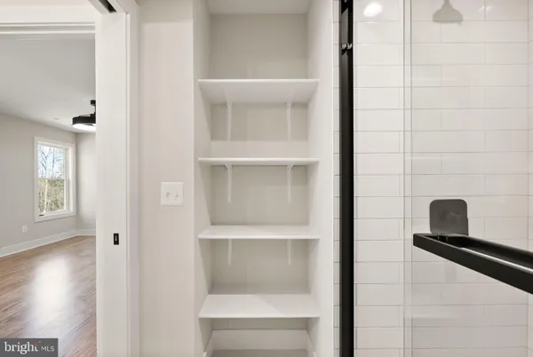 a view of a room with wooden floor and a hallway