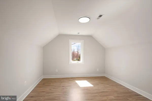 a view of a patio with table and chairs and wooden fence