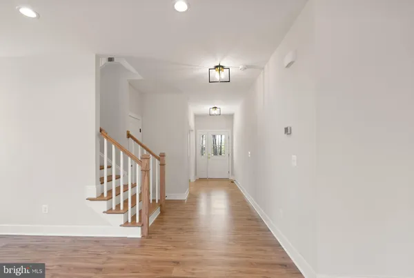 a view of a room with wooden floor and windows