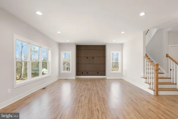 a view of a kitchen with wooden floor and windows