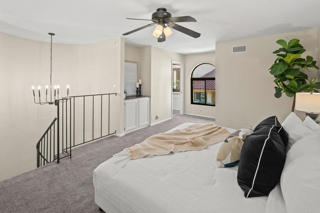 1939 Alga Road, Unit A Carlsbad, CA 92009 - Photo 11 of 32 a bedroom with a bed and a chandelier