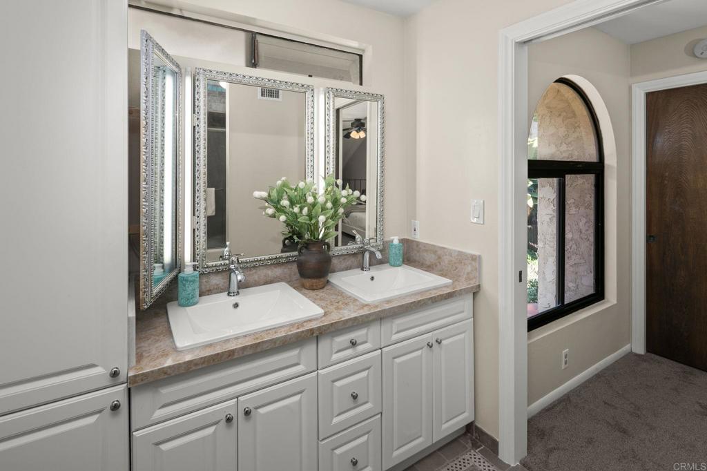 1939 Alga Road, Unit A Carlsbad, CA 92009 - Photo 13 of 32 a bathroom with a sink and a mirror