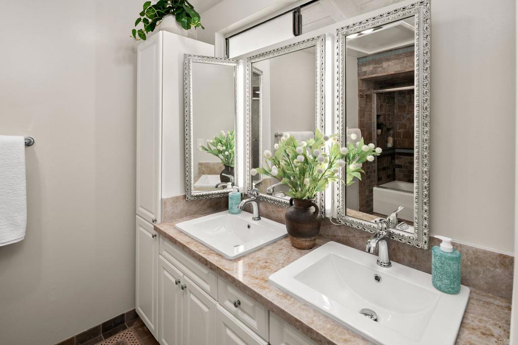 1939 Alga Road, Unit A Carlsbad, CA 92009 - Photo 14 of 32 a bathroom with a sink and a mirror