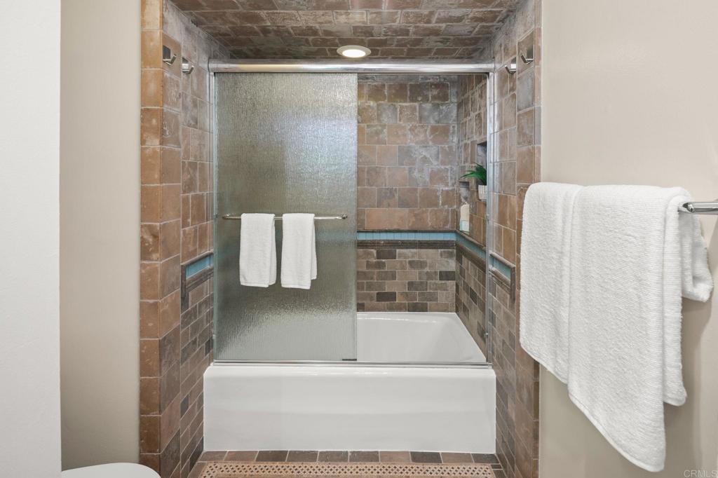 1939 Alga Road, Unit A Carlsbad, CA 92009 - Photo 15 of 32 a bathroom with a shower and a sink