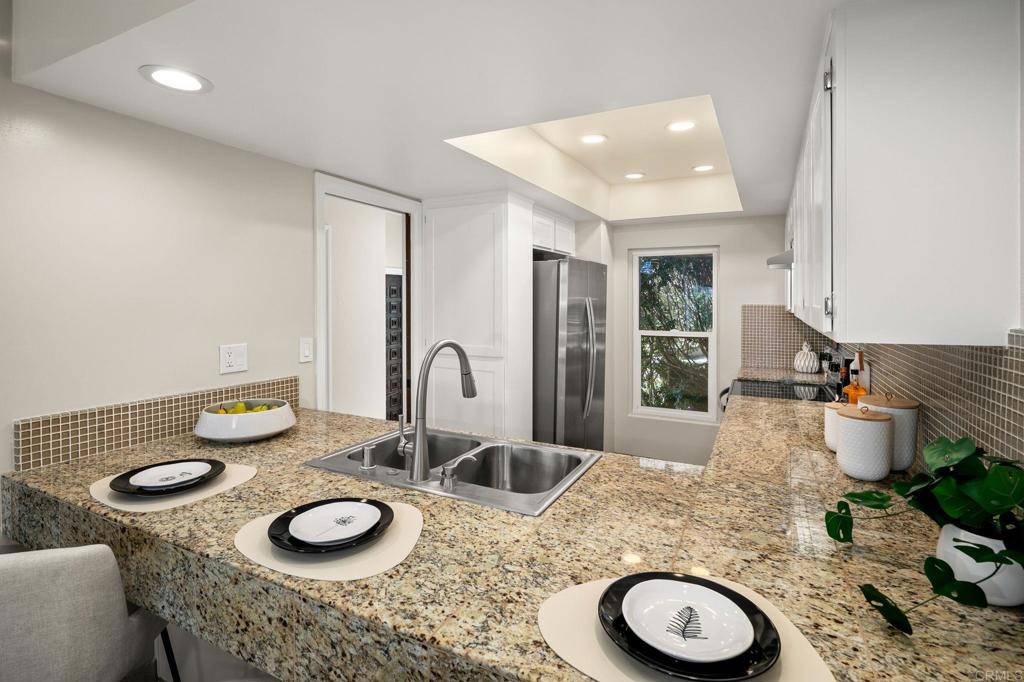 1939 Alga Road, Unit A Carlsbad, CA 92009 - Photo 16 of 32 a kitchen with a table and chairs