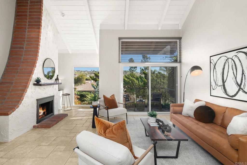 1939 Alga Road, Unit A Carlsbad, CA 92009 - Photo 2 of 32 a living room with furniture and a fireplace