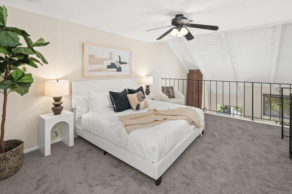 1939 Alga Road, Unit A Carlsbad, CA 92009 - Photo 28 of 32 a bedroom with bed and a chandelier