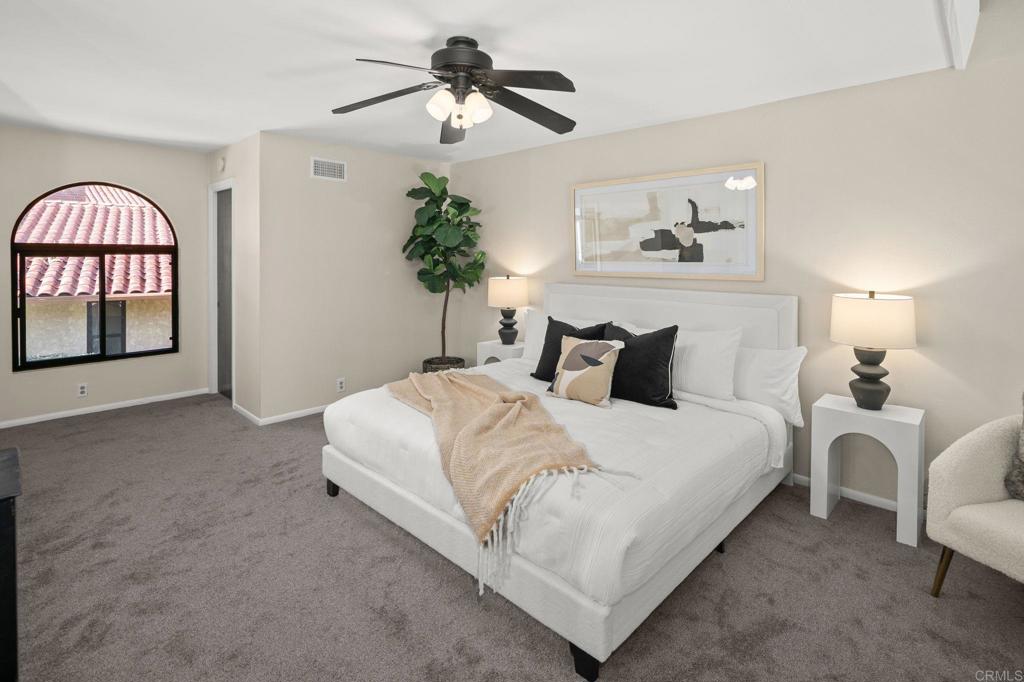 1939 Alga Road, Unit A Carlsbad, CA 92009 - Photo 31 of 32 a bedroom with bed and a chandelier