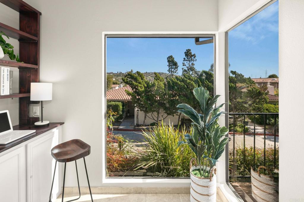1939 Alga Road, Unit A Carlsbad, CA 92009 - Photo 5 of 32 a vase of flowers sitting on a table with a potted plant