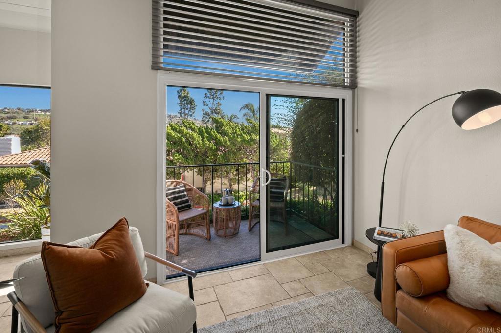 1939 Alga Road, Unit A Carlsbad, CA 92009 - Photo 6 of 32 a living room with furniture and a floor to ceiling window