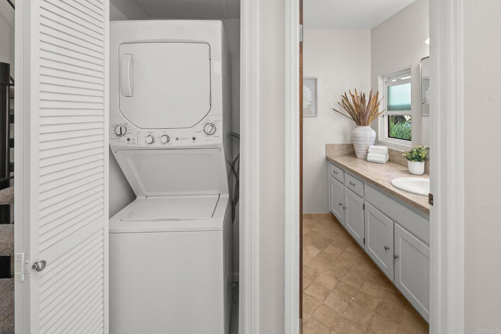 1939 Alga Road, Unit A Carlsbad, CA 92009 - Photo 10 of 32 a bathroom with a granite countertop sink a toilet and a mirror