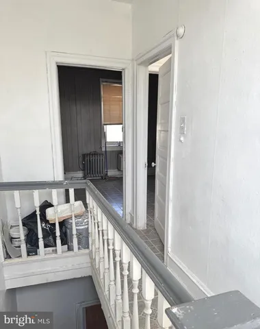 a kitchen with white cabinets and a sink
