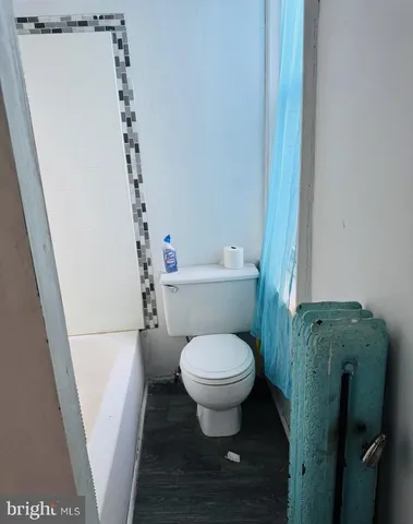 a bathroom with a bathtub and a toilet