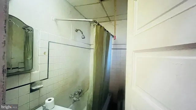 a bathroom with a shower and a mirror