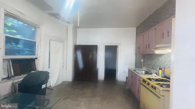 a kitchen with stainless steel appliances granite countertop a refrigerator and a stove