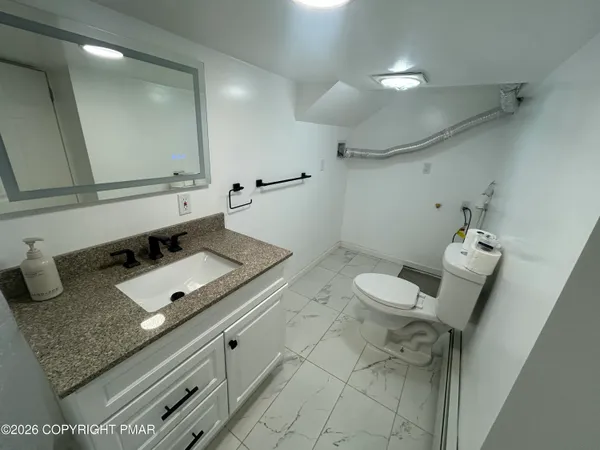 a kitchen with stainless steel appliances a stove a sink and a microwave